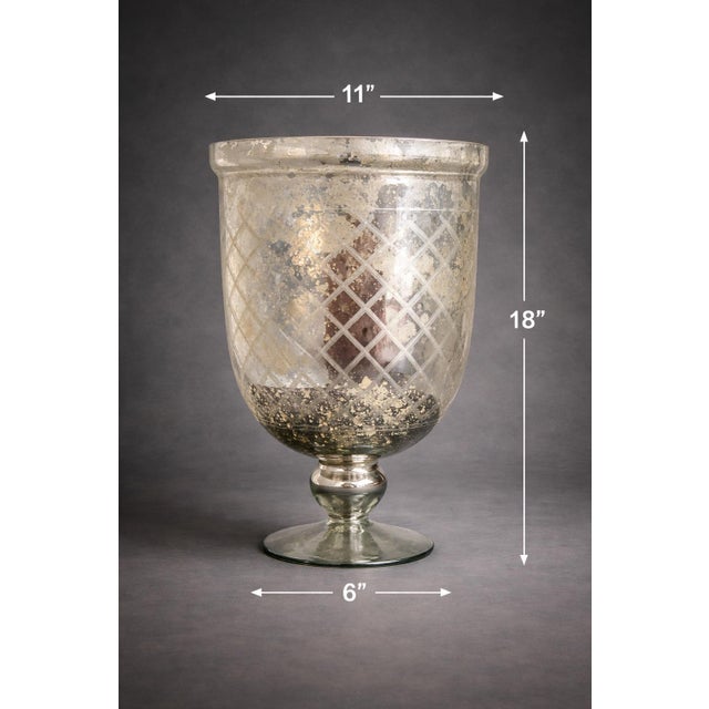 Mobile-Ready Description A striking statement in reflective texture and form, this large mercury glass urn vase features...