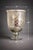 Mobile-Ready Description A striking statement in reflective texture and form, this large mercury glass urn vase features...