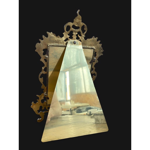 A gilt bronze and openwork photograph frame decorated with scrolls, shells, and foliate tendrils in the Rocaille/Rococo...