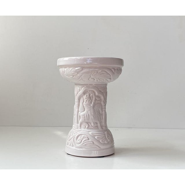 A medieval christian themed baptismal font in the shape of a column candleholder for 3 regular sized candles. Decorated...