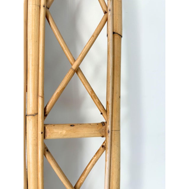 A large mid 20th century Italian bamboo wall mirror. This vintage piece has a rectangular mirror glass is surrounded by an...