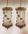 A pair of unusual lantern style hanging fixtures characterized by open work butterfly wings resulting in a pierced,...