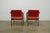 This pair of vintage mid century modern armchairs showcases a refined maple frame with sculptural lines and vibrant red...