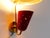 Mid-century Swiss wall lamps by B.A.G. Turgi, clearly influenced by Mathieu Matégot, featuring a perforated brass...