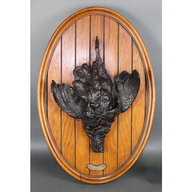 Antique French Black Forest bronze trophy plaque with bird on oval pine panel. Small plaque below bird that says "Perdir",...