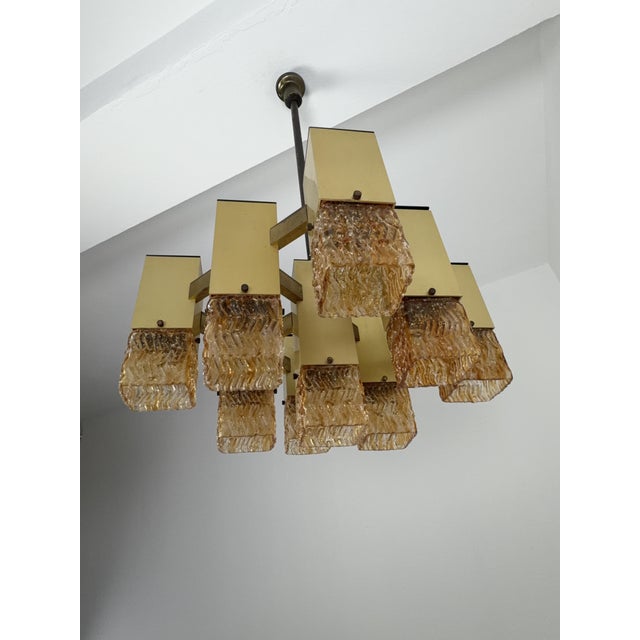 Nine-light chandelier in the style of Gaetano Sciolari for Stilnovo, 1970 Modular, geometric structure in gold-plated...
