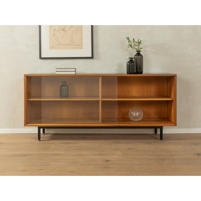A classic sideboard by Lothar Wegner from the 1960s. High-quality walnut veneer body with two glass sliding doors, two...