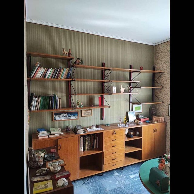 Elegant sideboard with wall-mounted bookcase from the 1970s, an iconic piece of vintage design. Crafted from fine wood, it...