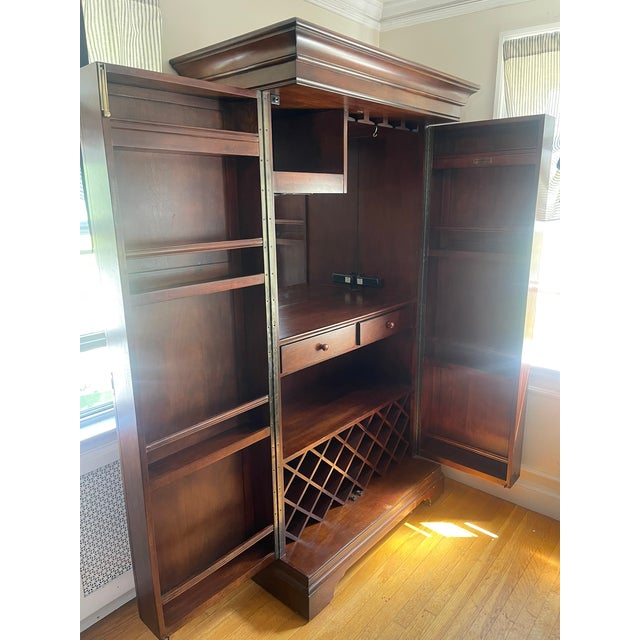 Beautiful Howard Miller entertainment bar and wine cabinet in a rich cherry finish. Like-new condition and designed to...