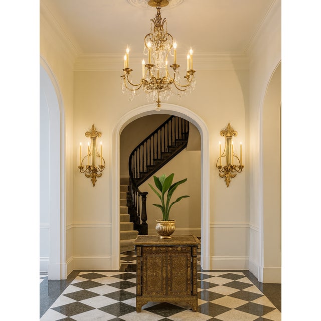 Offering a pair of vintage Neoclassical inspired gold wall sconces circa Late 20th century. These large sconces each hold...