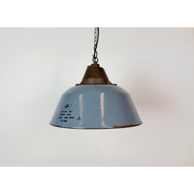 Industrial hanging lamp manufactured by Szarvasi Vas - Fém in Hungary during the 1960s. It features a grey enamel shade,...