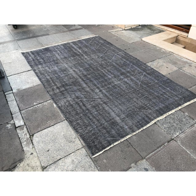 This is a vintage Turkish Oushak rug from the 1960s. The piece was hand-knotted.