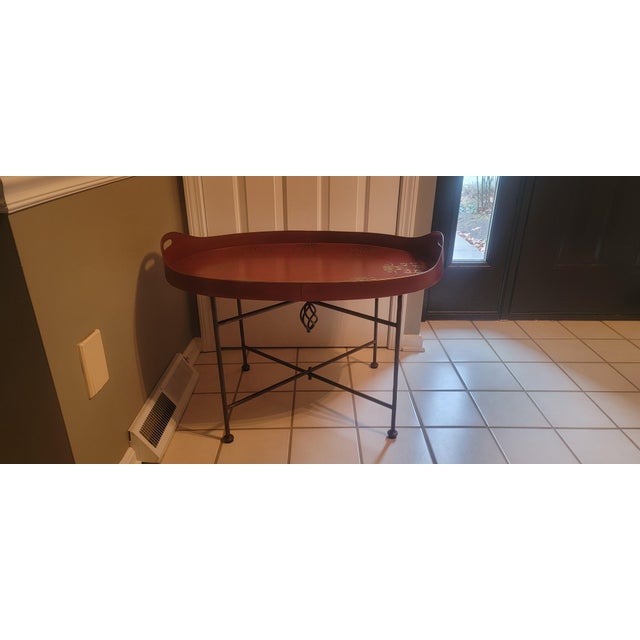 Mid 20th Century vintage Dutch hand-painted metal tray top accent table on stand with folding legs. It features a...