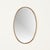 Elegant and refined oval wall mirror in solid brass, realized in Italy during the 1950s and inspired by the iconic designs...