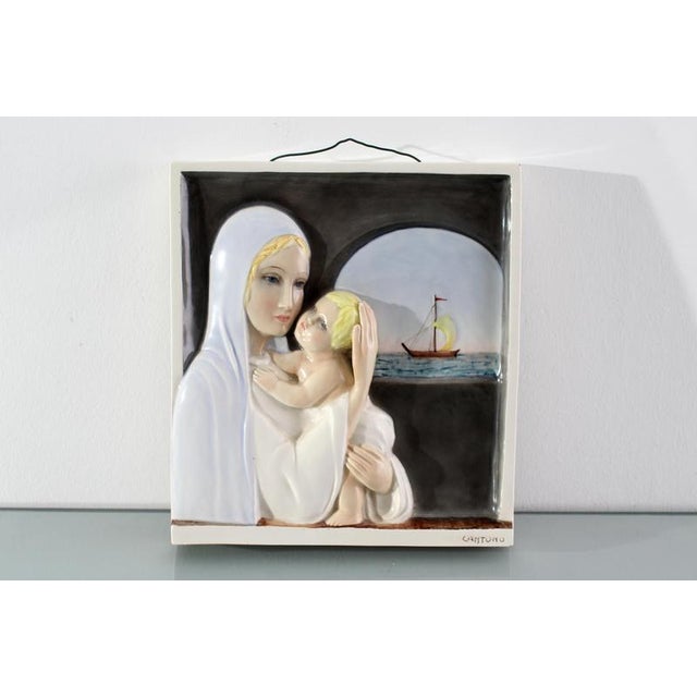 "Madonna del Navigatore," glazed ceramic bas-relief, depicting the Madonna and Child with a ship in the background....
