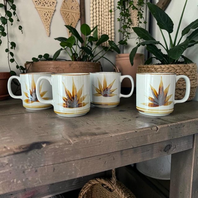 Set of 4 vintage coffee mugs, one has a small chip in the lip.