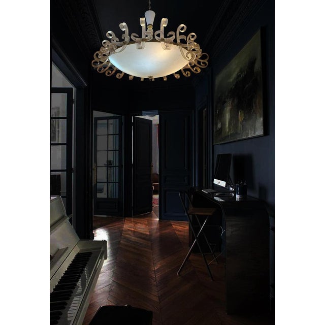 Elegant Murano chandelier with an original and sophisticated shape, very fashionable in the 1950s. The sinuous glasses...