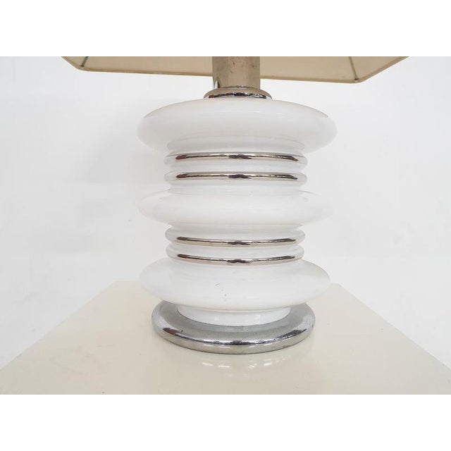 About this item White illuminated glass table light white chrome details. with the original plastic lamp shade. Base has a...