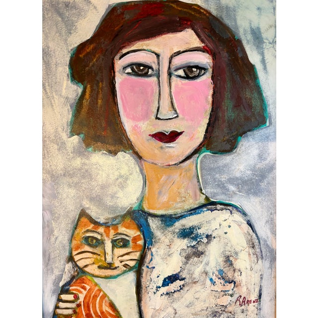 Delightful portrait of a young woman holding her cat by self-taught US artist Ruth Arenz. Paint on wood, signed on recto,...