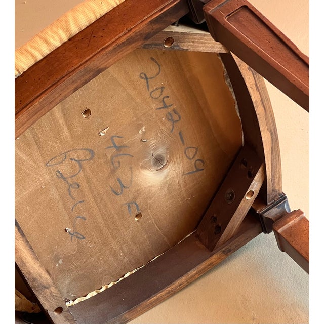 An antique hand-carved late Victorian wooden chair with rush wicker back and iron fixture at crest, late 19th century or...