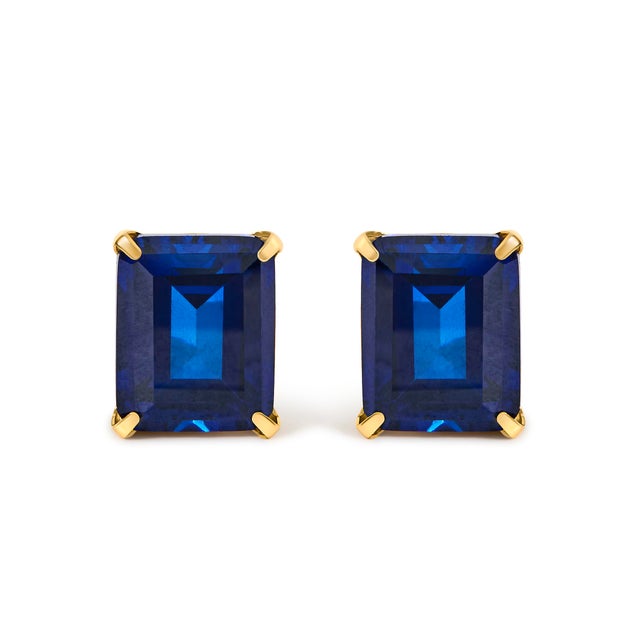 Saturated with midnight allure, these emerald-cut blue sapphires command attention with sculptural step facets that ripple...