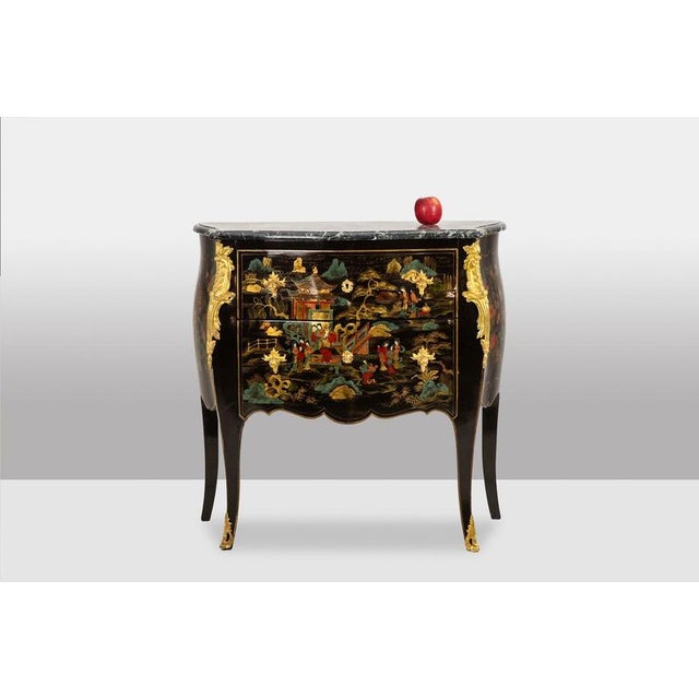 A lacquered, gilded bronze, and marble chest of drawers with two drawers on the front. A French piece made in the 1950s....