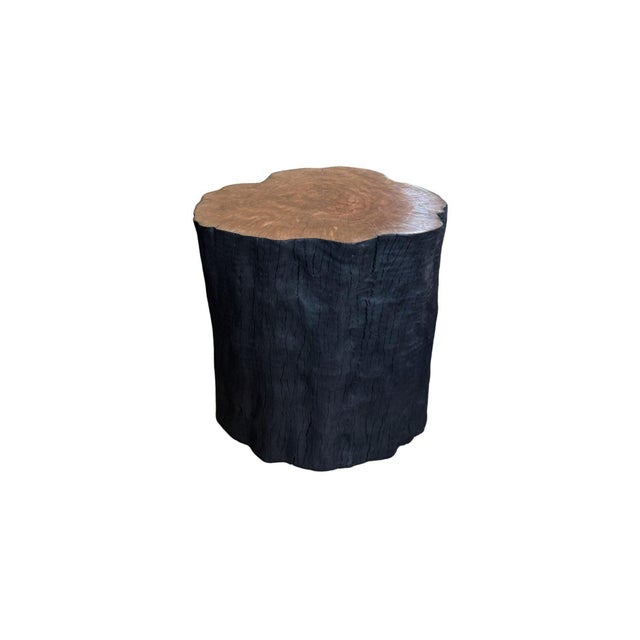 A sculptural side table hand-crafted from solid lychee wood by skilled artisans on the island of Bali. The piece is...