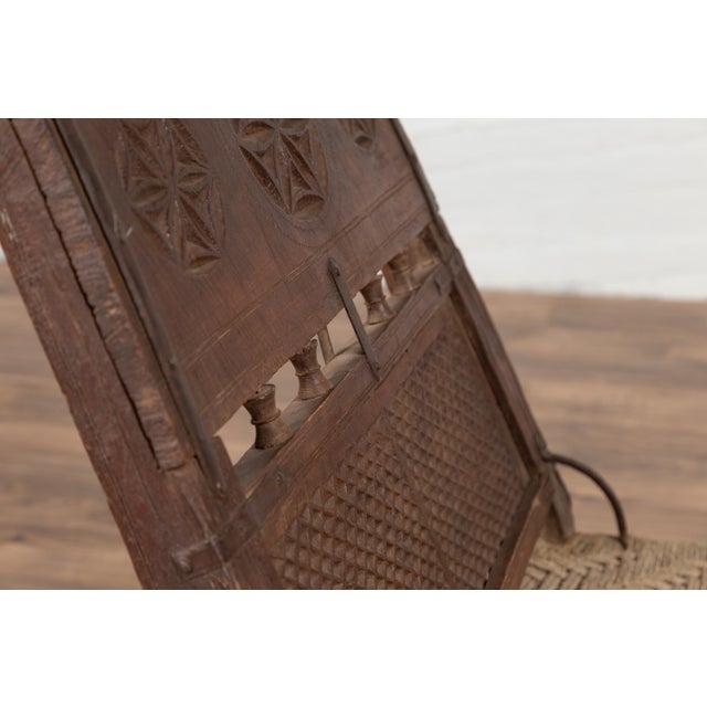 Antique Indian Rustic Low Seat Wooden Chair with Carved Rosettes and Twine Seat For Sale - Image 4 of 12