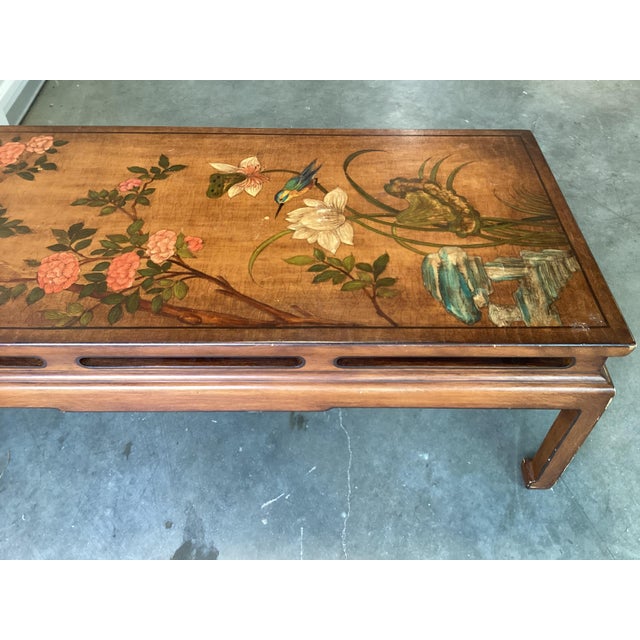 This painted Asian coffee table features a well-executed floral theme decor. On a light wood background, there are a...