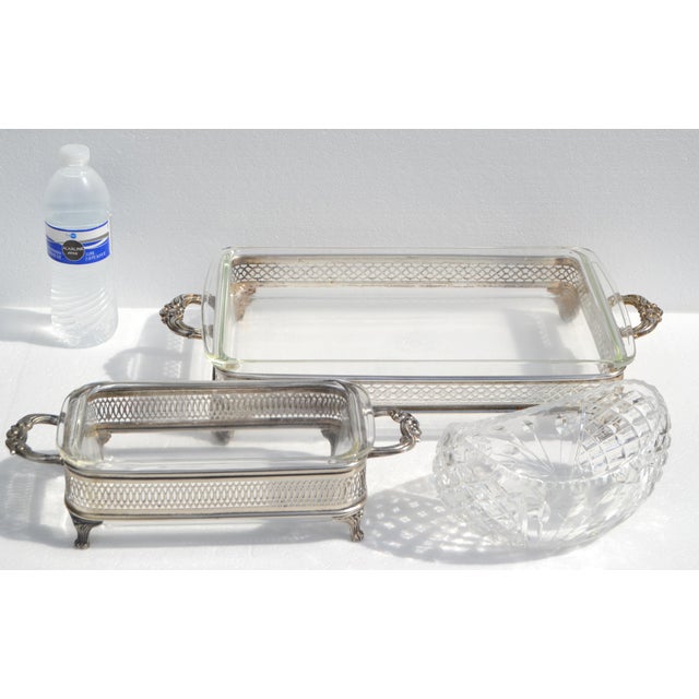 Set of two 1950s Vintage Pyrex baking dishes with silver-plated footed Holders or Stands combine oven-safe functionality...