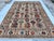 This stunning hand-knotted wool area rug features a classic Afghan Kazak tribal design. The field is filled with rows of...