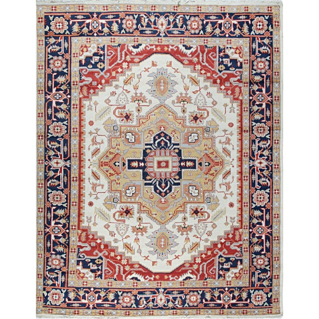 A hand-knotted wool rug in a classic traditional design, made in India and measuring 10' x 14'. Floral drawing across the...