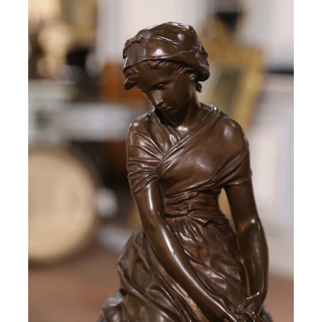 Decorate a desk, library shelf, or lady’s office with this elegant antique bronze sculpture titled La Cruche Cassée (The...