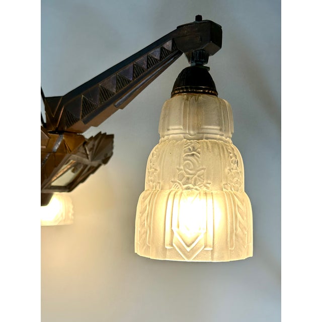 Art Deco style four-light chandelier in the Degué style, crafted from chased nickel silver (a copper, zinc, and nickel...