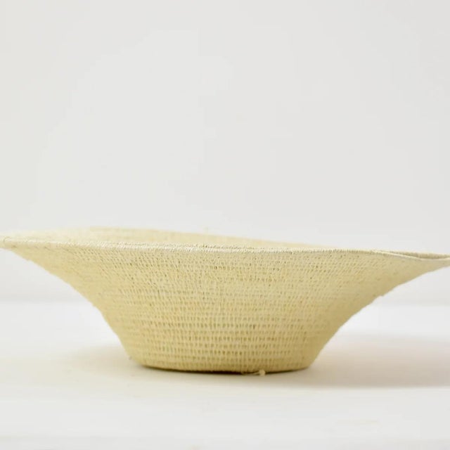 An open coiled basket made from papyrus plants.Â The art of making baskets has become one of the most lucrative activities...
