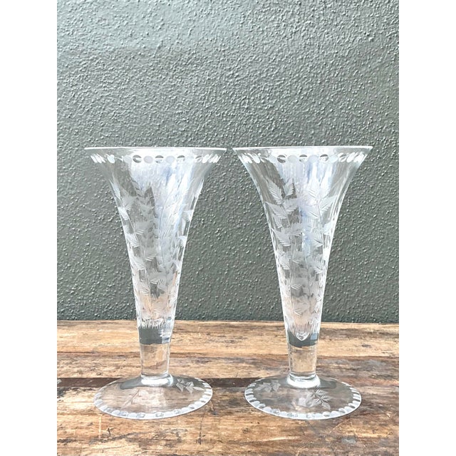 Elevate your tabletop with this exquisite pair of vintage etched glass trumpet vases. Featuring a classic flared...