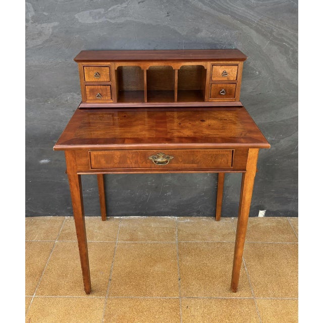 Elegant Louis XVI style writing desk dating to the early 20th century. The desk features a rectangular writing surface...