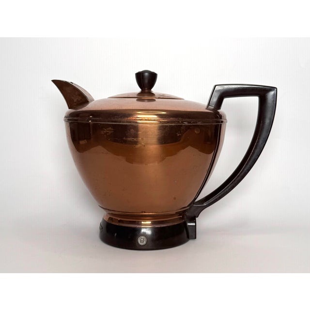 This copper tea pot/kettle from the Mid Century exudes Art Deco design. From clean lines of the silhouette on the kettle...