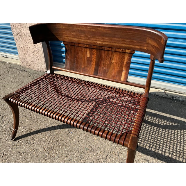Modern walnut Klismos style settee/bench. The bench is made of solid walnut. The leather cording on seat is flawless. The...