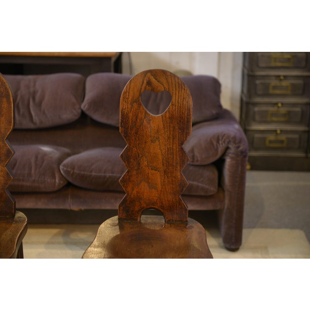 Set of four Brutalist oak chairs from the 1950s, with a sculptural character. The solid, carved backs feature heart-shaped...