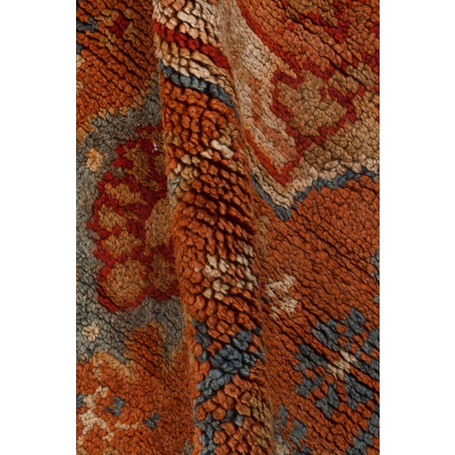 Evoking the grandeur of Anatolias weaving legacy, this monumental antique Oushak rug from the early 20th century is a...