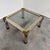 A striking 1970s hollywood regency coffee table combining polished chrome, warm brass accents and a substantial inset...