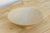 This one leads with form and surface rather than color. A wide, flared conical bowl in a soft matte ivory glaze, its...