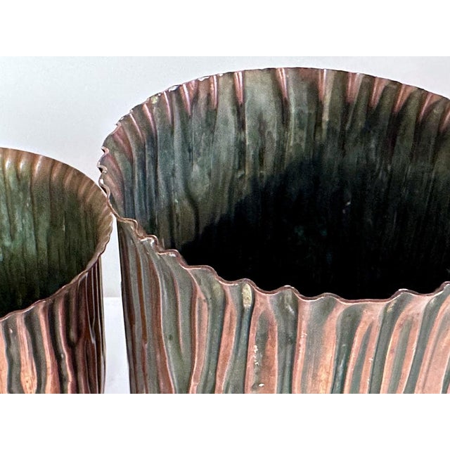 This fine set was handcrafted in Germany during the 1920s. An impressive pair of small Art Deco flower pots in copper,...