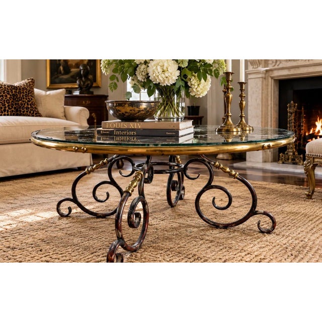 An elegant mid-20th-century round cocktail or coffee table in the Maison Jansen / French Hollywood Regency tradition,...