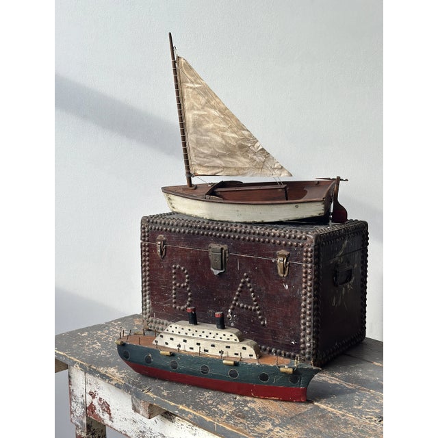 Antique Folk Art Wood Pond Sail Boat, Circa 1920s. Constructed from wood with carved and painted details. The hull of the...