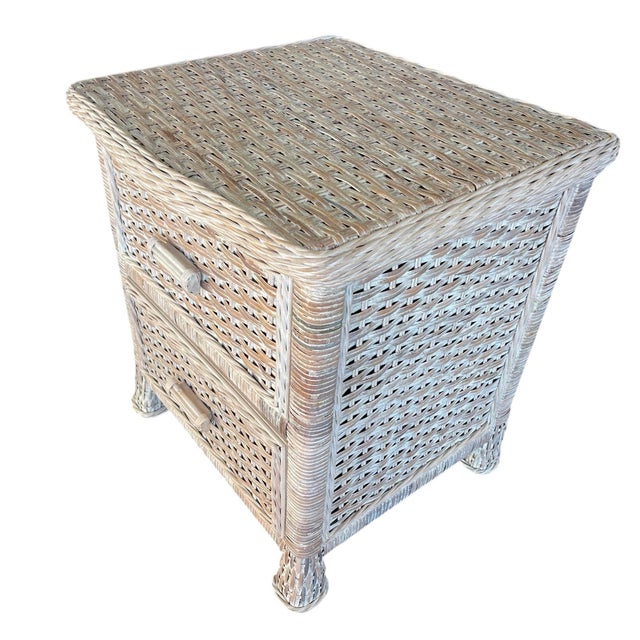 These are a matching pair of woven rattan nightstands with a relaxed, coastal look. Each piece has a rectangular form with...