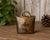 A wonderfully aged vintage German metal cowbell featuring a rich distressed gold-tone surface with deep blackened patina...
