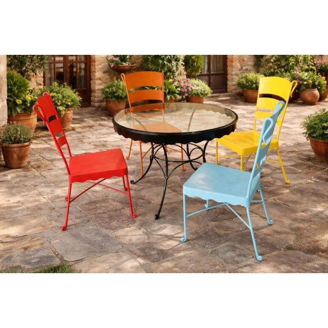 A striking and substantial mid-century modern outdoor bistro set dating to the 1950s–1960s. This set features four heavy-...