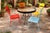 A striking and substantial mid-century modern outdoor bistro set dating to the 1950s–1960s. This set features four heavy-...